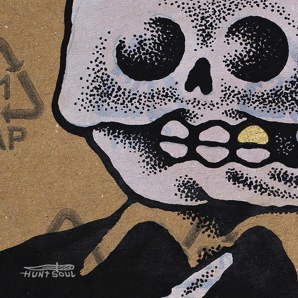 Close-up of printed artwork showing surreal details and skeletal imagery
