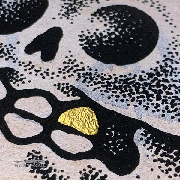 Close-up of printed artwork showing surreal details and skeletal imagery
