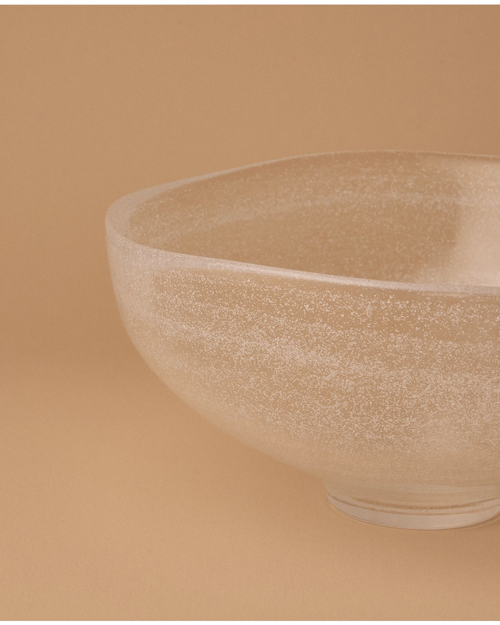 Fine bubble texture inside thick transparent glass bowl